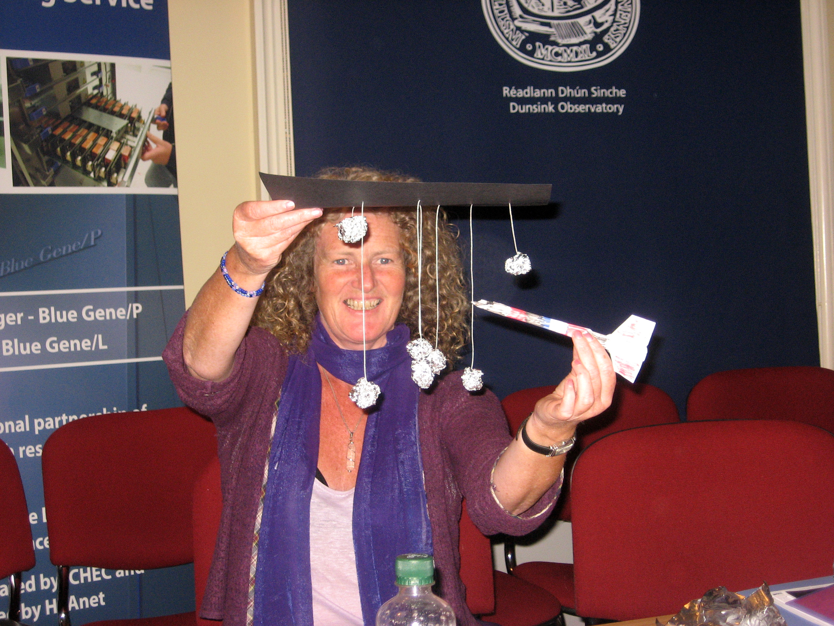 Teacher with constellation and foam rocket