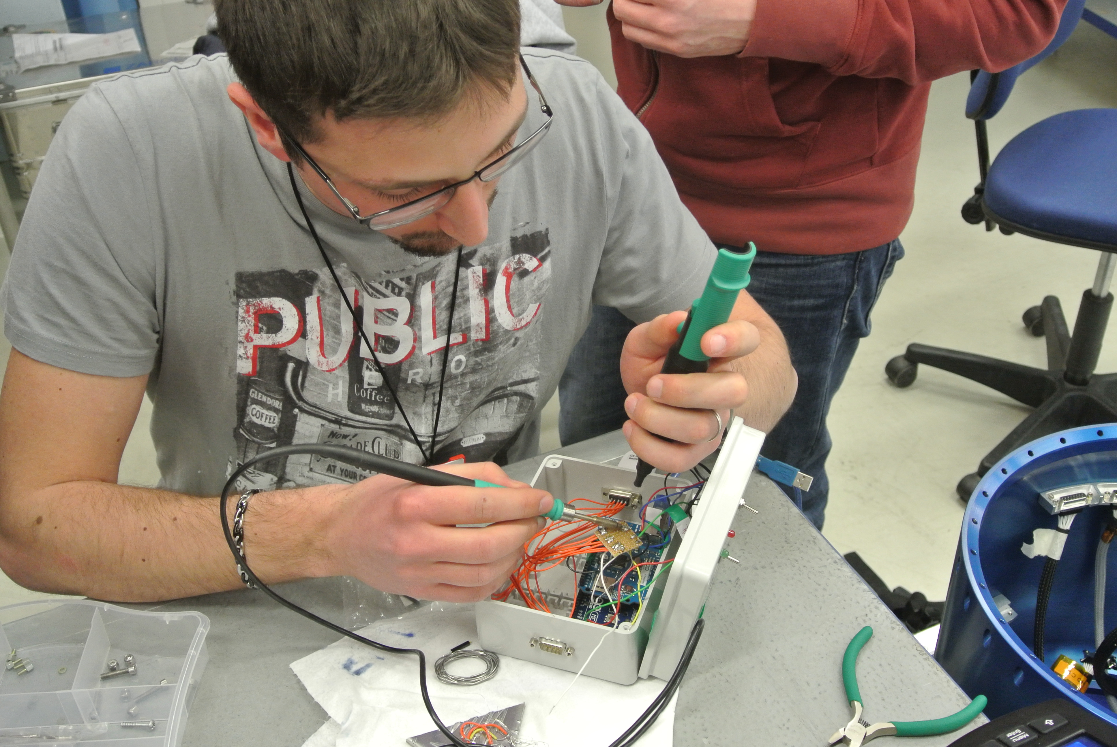 PHOS student desoldering a component