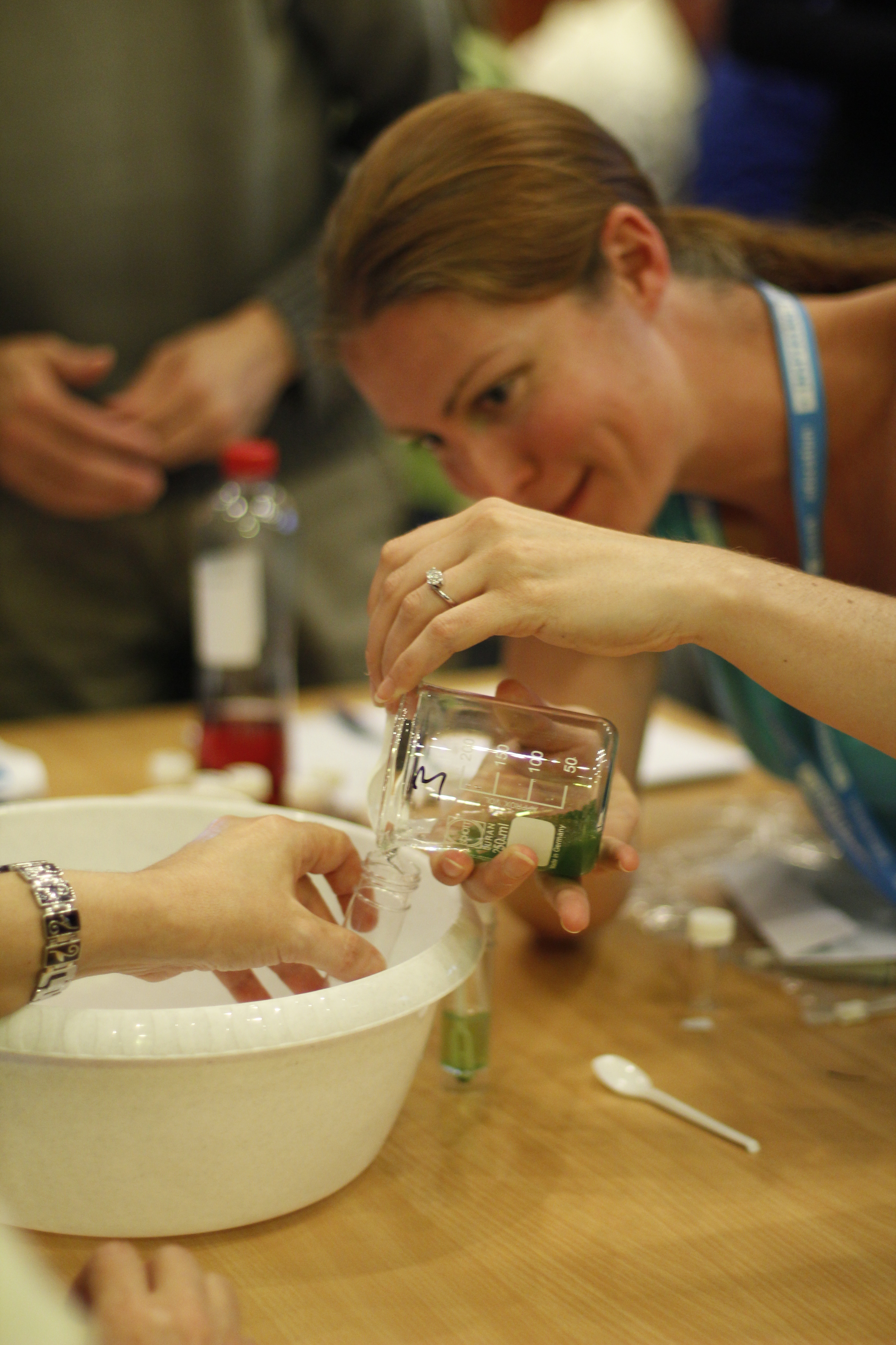 Teacher performing experiment with spirulina cells