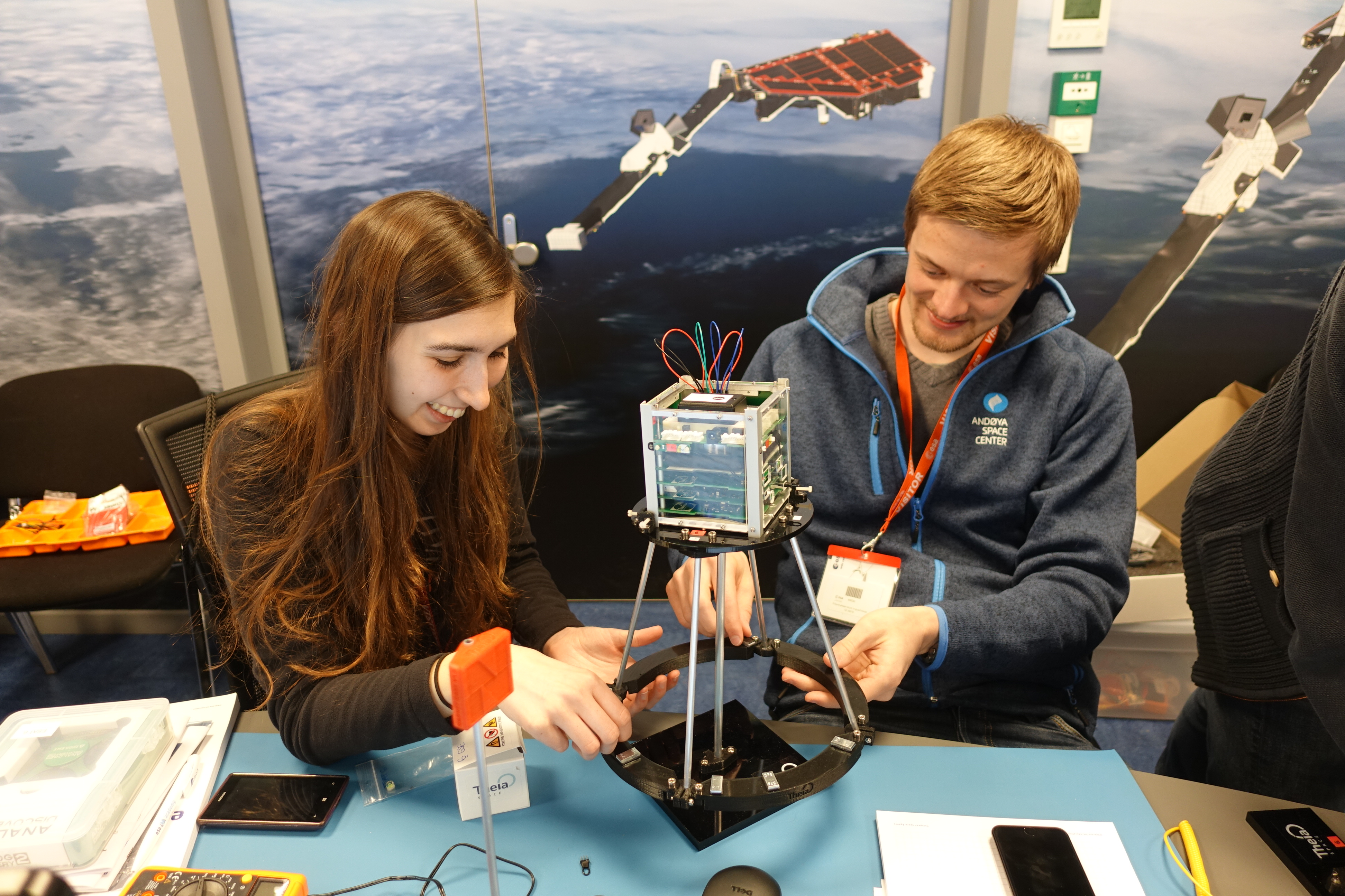 Students performing experiments on their ESAT model
