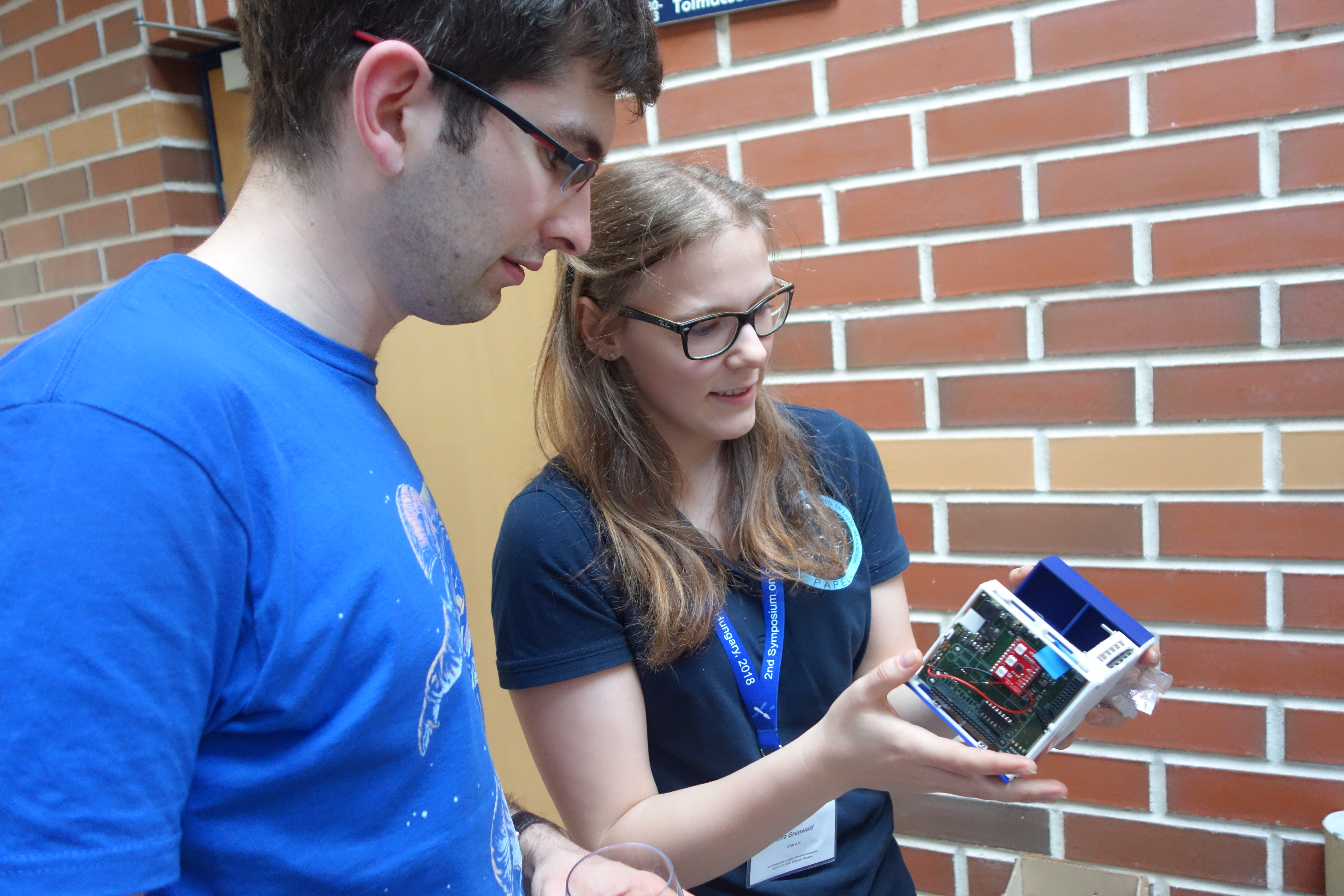 Students discussing an educational cubesat project