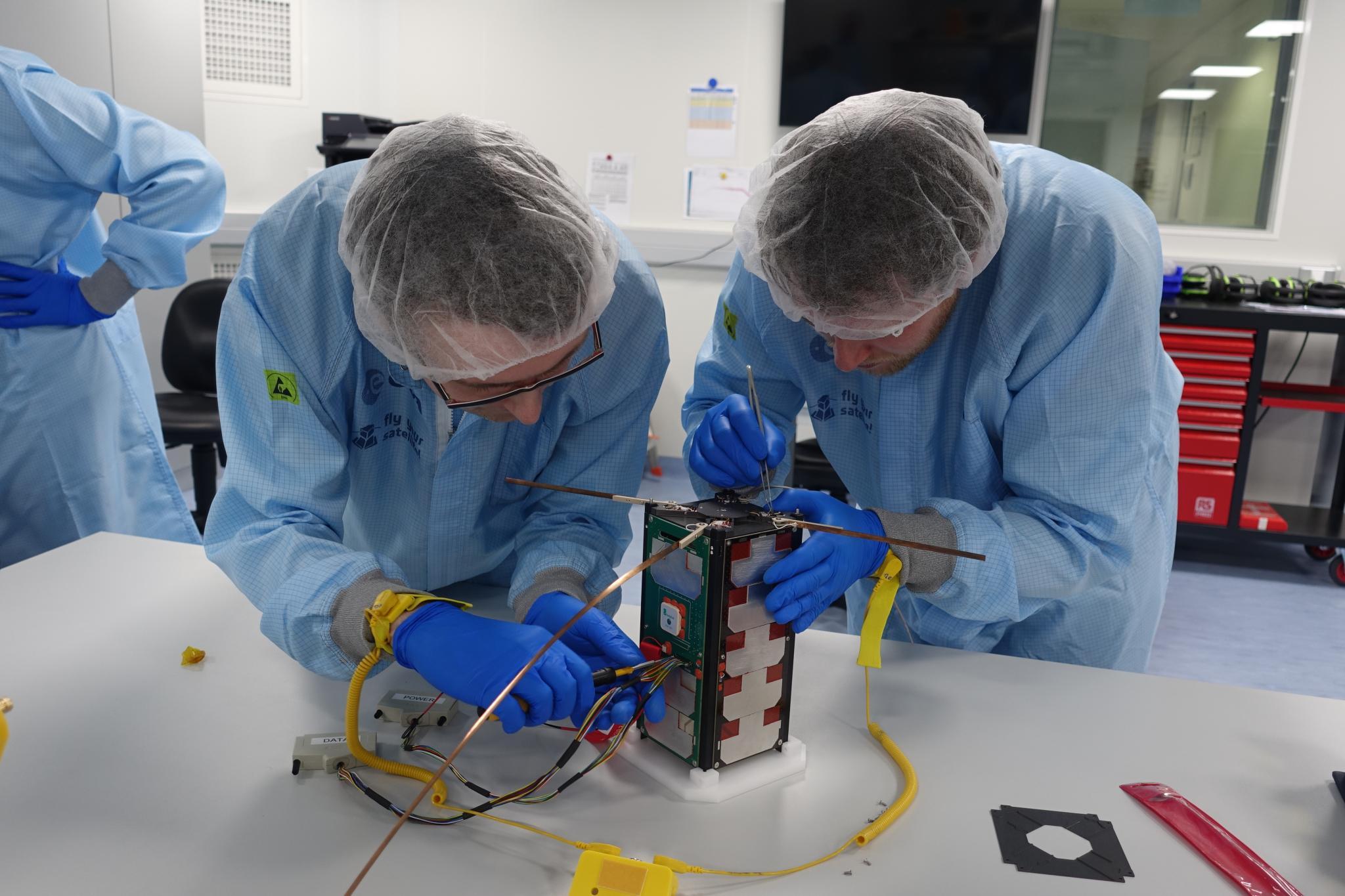 Students performing checks on their CubeSat