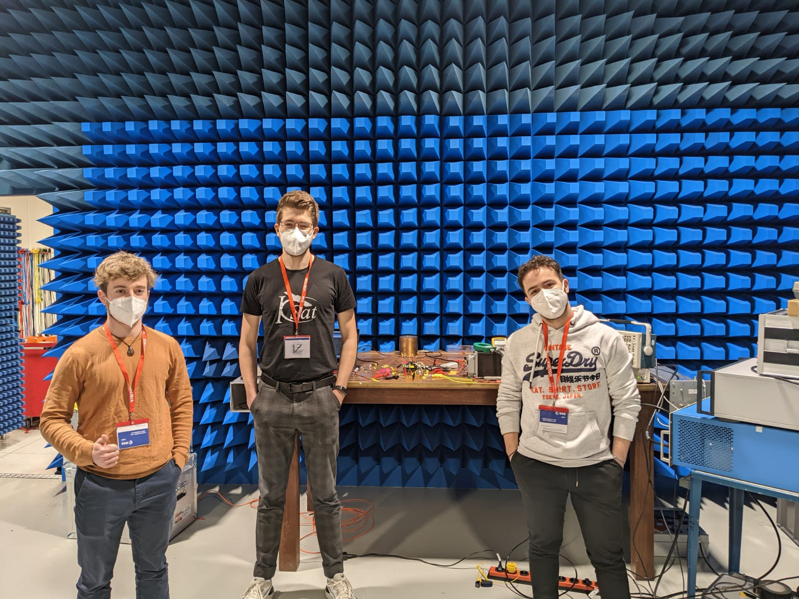 The three students from the SOURCE team next to their PCDU