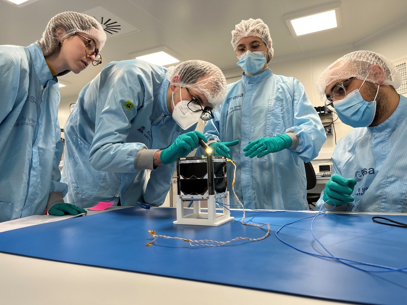 Students inspecting ISTSat-1.